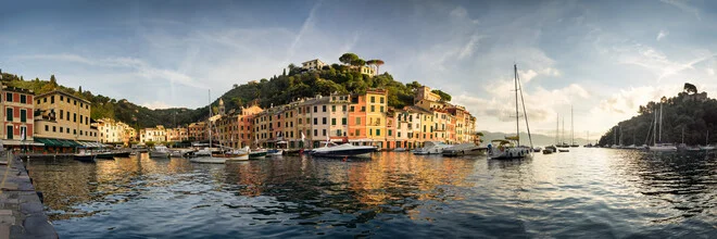 Port of Portofino at sunrise, calm water surface and gentle light mood.