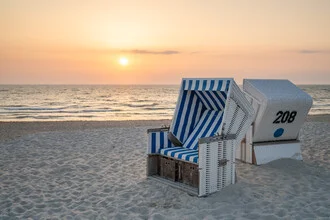Sunset on the North Sea beach with gentle waves and a calm atmosphere.