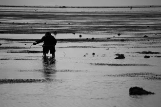 Photo art of a fisherman in Tonga: calm scene by the water with gentle waves