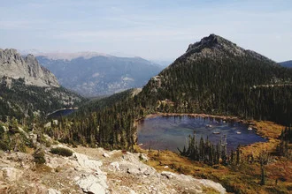 Photo art by Kevin Russ: tranquil Lake Helene surrounded by mountains in the rocky park