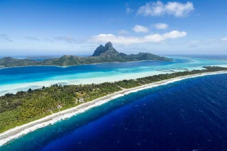 Aerial view of Bora Bora: tropical lagoon with clear water and Mount Otemanu in the background