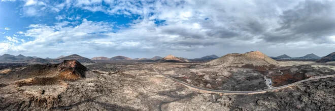 Photo art by Miro May: volcanic landscape with barren earth and a prominent crater.