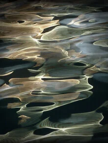 Abstract photo featuring waves and light reflections in soft green tones