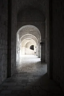 Photo art: serene architectural shot featuring arches in a historic cityscape.