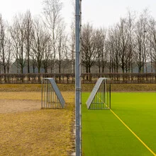 Photo by Franz Sussbauer: two football goals on a playfield.