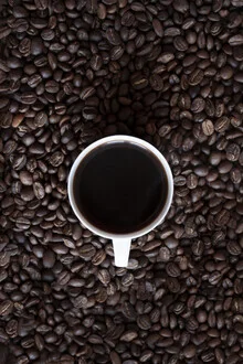 Black coffee in a cup on a minimalist table, calm morning atmosphere.