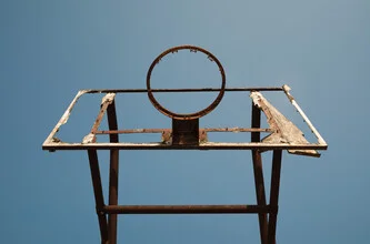 Photo art by AJ Schokora: Basketball game in an urban setting under a clear sky