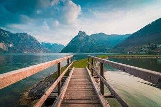 Serene view at Lake Traunsee featuring a pier and mountains in the background