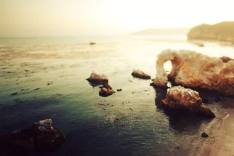 Photo art by Kevin Russ: Sunset over rocks by the Pacific Ocean