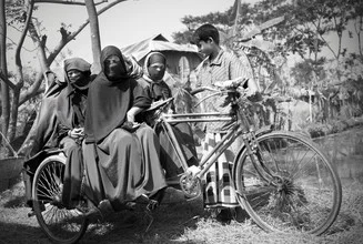 Wall art of a rickshaw puller with customers in Bangladesh.