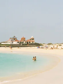 Photo art by Fabian Heigel: tranquil beach scene with gentle waves and blue sky.