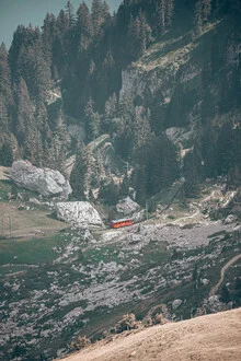 Photo art by Eva Stadler: small train climbing a mountain landscape