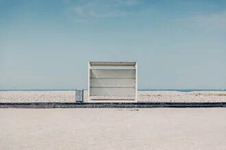 Photo art by Eva Stadler: lonely bench on the beach in Le Havre, minimal mood.