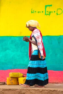 Colorful photo of a woman with a mobile phone in a lively street in Ethiopia