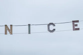 Photo art by Roman Becker: cheerful minimalist sign featuring the word 'NICER'