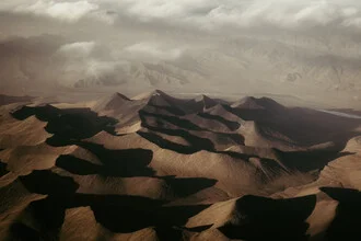 Aerial view of sand dunes, soft waves and harmonious colors in a desert landscape.