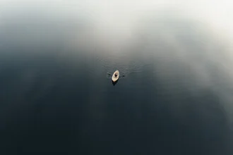 Calm morning scene with a rowboat on a Finnish lake.