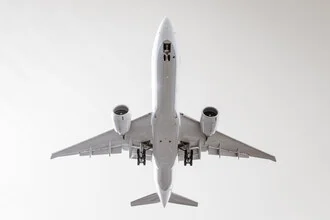 Photo art by Roman Becker: airplane gliding gently through the sky.