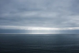 Photo art depicts a calm seascape with gentle waves and warm light.