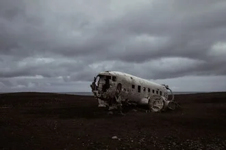 Photo art by Roman Becker: airplane over calm beach in dark, rainy mood