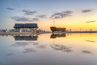 Photo art: Sunrise over the beach of Sankt Peter-Ording with calm water.