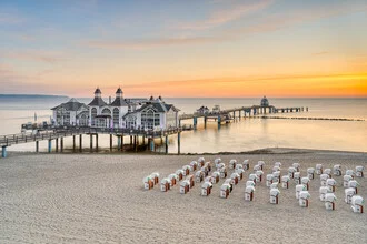 Sunrise over the pier in Sellin with gentle sea waves