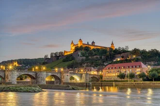 Würzburg at dusk featuring the Marienberg Fortress in the background.