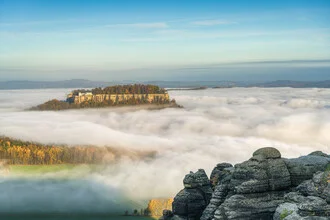 Photo of Fortress Königstein surrounded by a sea of fog in Saxon Switzerland