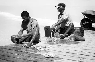 Photo art by Jochen Fischer: fishermen working on the shore of Cape Verde.