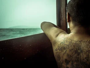 Photo art by Johann Oswald: fisherman at sea during a rain shower