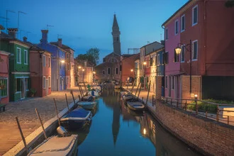 Night photo of Burano: calm canal with gondola during the blue hour