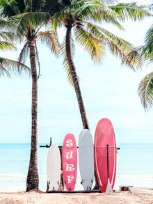 Lovely pink surfboard with palm trees by the beach