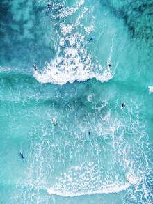 Photo art by Gal Pittel: surfers riding waves under a blue sky