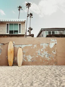 Wall art: Surfer enjoys the waves under a colorful sunset in California.