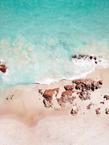 Photo art by Gal Pittel: gentle waves on the beach under a clear sky