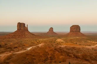 Landscape photo with an orange sunset over Monument Valley