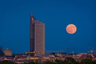 Photo art: Full moon over the city of Leipzig with skyscrapers in the foreground