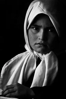 Fotokunst: Mädchen in Kabul, freundlich lächelnd in einer Schulumgebung.
