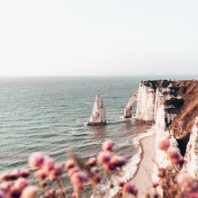 Photo art by Eva Stadler: white cliffs in Normandy beneath a blue sky.