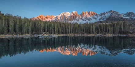 Panorama of Lake Carezza in Italy with gentle alpenglow at sunset