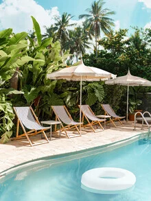 Photo art: relaxing pool scene with an umbrella and palm trees in the background