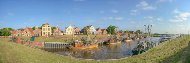 Panoramic view of Greetsiel with boats in the harbor and a northern German atmosphere