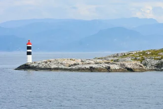 Photo art by Lotte Wildiers: serene coastal landscape with a beacon in Norway