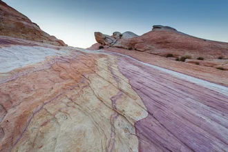 Colorful rock formations in Death Valley displaying the desert in soft hues.