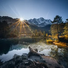 Calm sunrise over Lake Eibsee with gentle reflections of the mountains