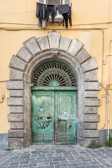 Grüne Tür in Italien, mediterraner Stil mit gelbem Rahmen, freundliche Stimmung.