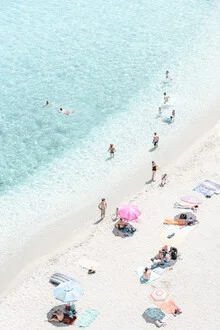 Relaxed beach in Calabria with an umbrella and gentle waves.