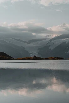 Calm reflection of a lake in Austria under a clear sky.