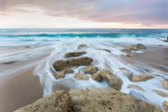 Relaxing beach scene with gentle waves and a calm atmosphere.