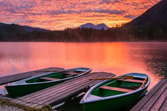 Dawn at Lake Hintersee with calm waters and gentle mountain silhouettes.